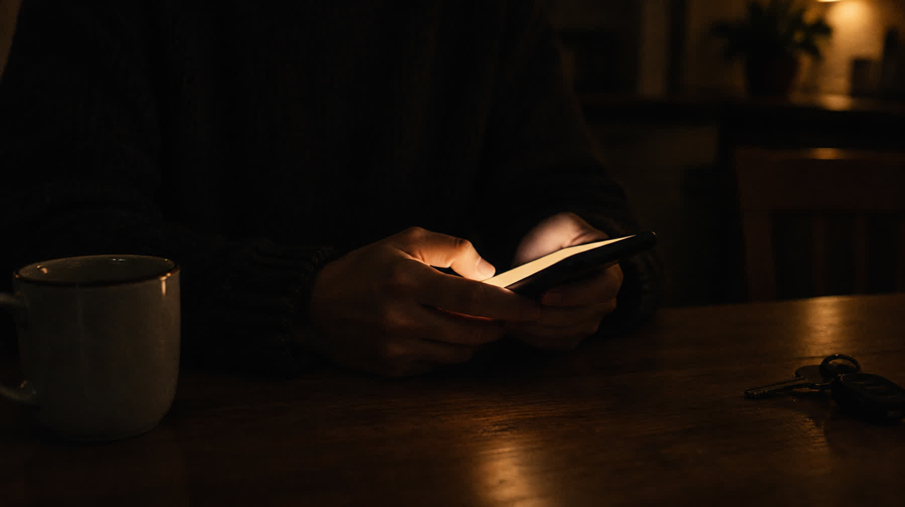 A customer looking at their phone late in the evening